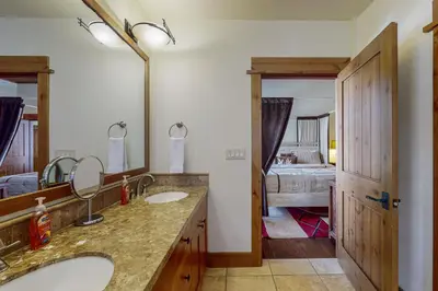 a bathroom with two sinks and a bedroom at Northstar Escape + Northstar Getaway in Truckee