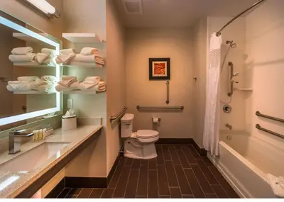 a bathroom with a toilet and a sink and a tub at Hampton Inn & Suites - Reno West, NV in Reno