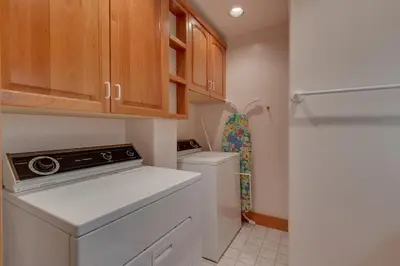 a small kitchen with a washer and dryer at Rubicon Bay Lakefront by Tahoe Getaways - 4BR with Bonus Room, Private Pier, Buoy & Beach Access in Tahoma