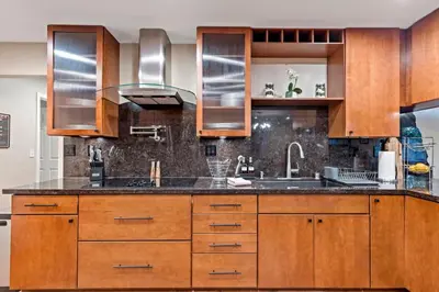 a kitchen with wooden cabinets and a sink at Huge House-Yard-Pool Hot Tub in Citrus Heights