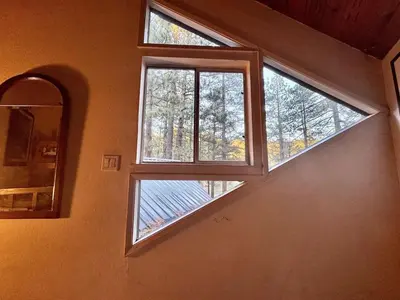 two windows in a room with a mirror at One The First Fairway - Walk to the Lake in Incline Village