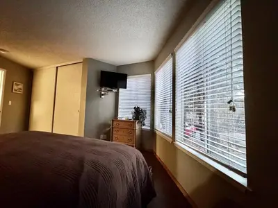 a bedroom with a bed and a large window at One The First Fairway - Walk to the Lake in Incline Village