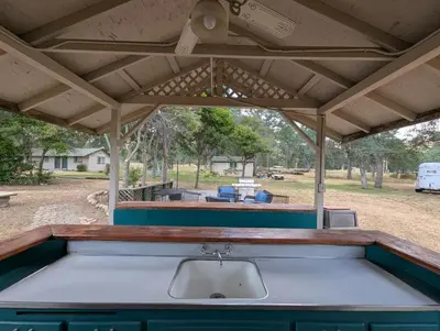an outdoor kitchen with awning and a sink at Squaw Valley Motel Room 6 in Squaw Valley
