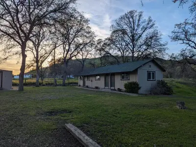 a house in the middle of a yard at Squaw Valley Motel Room 5 in Squaw Valley