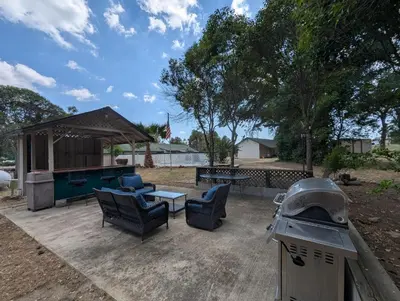a backyard with a pool table and chairs and a grill at Squaw Valley Motel Room 3 in Squaw Valley