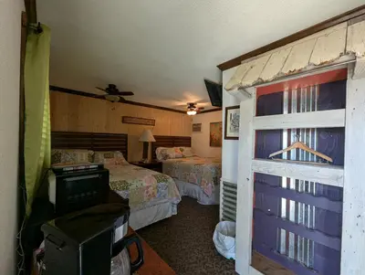 a hotel room with two beds and a window at Squaw Valley Motel Room 7 in Dunlap
