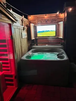 a bathroom with a tub with a television in it at Reno Romantic Couples Retreat in Reno