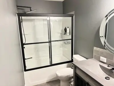 a bathroom with a shower with a toilet and a sink at Romantic Couples Retreat - Tahoe Room in Reno