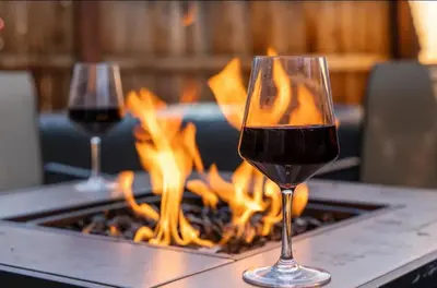two glasses of red wine in front of a fireplace at Romantic Couples Retreat - Tahoe Room in Reno