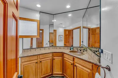 a bathroom with a sink and a large mirror at Luxury Truckee Retreat with Hot Tub and Sauna in Truckee