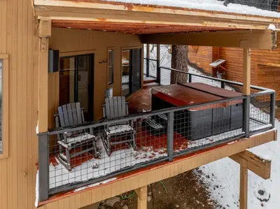 a screened porch with chairs on a house at Luxury Truckee Retreat with Hot Tub and Sauna in Truckee