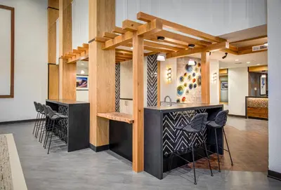 a bar in a room with stools at Palisades Tahoe Lodge Rentals Premium Fireplace One Bedroom #807 in Olympic Valley