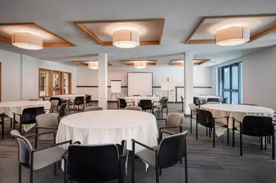 a conference room with tables and chairs and a chalkboard at Palisades Tahoe Lodge Rentals Premium Fireplace One Bedroom #807 in Olympic Valley