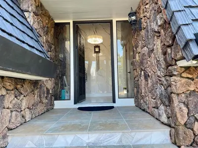 a room with a stone wall and a window at The Grand Waterside Estate Easy drive to Yosemite in Modesto