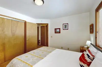 a bedroom with a white bed and a window at North Shore Escape in Carnelian Bay