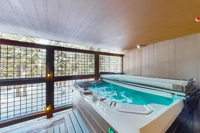 a large swimming pool in a room with windows at Northstar Paradise in Ponderosa Fairway Estates