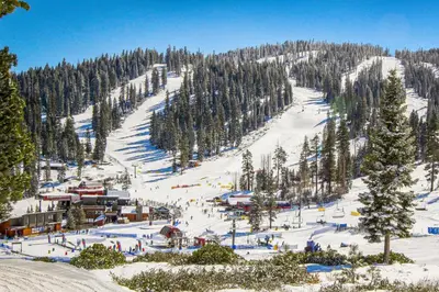 a snowy ski slope with a ski lodge and trees at Northstar Paradise in Ponderosa Fairway Estates