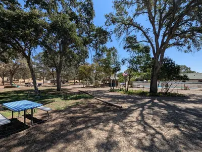 a park with a blue bench and trees at Squaw Valley Motel Room 2 in Squaw Valley
