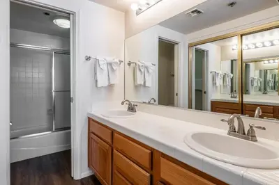 a bathroom with two sinks and a large mirror at Silverbear #41 - 2 Bedrm + Loft / 3 Bathrm 1/2 block to Canyon Lodge! Slps 8 in Mammoth Lakes