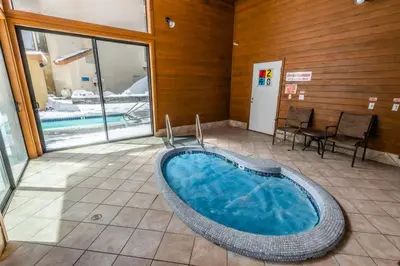 a large bath tub in a room with a pool at Silverbear #41 - 2 Bedrm + Loft / 3 Bathrm 1/2 block to Canyon Lodge! Slps 8 in Mammoth Lakes