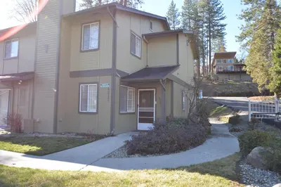 a house with a driveway in front of it at Bearadise At North Shore Winter Special in Bass Lake