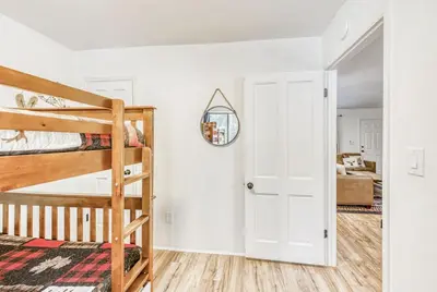 a bedroom with two bunk beds and a mirror at Blue Basecamp - Adventure Starts HERE! in Shaver Lake