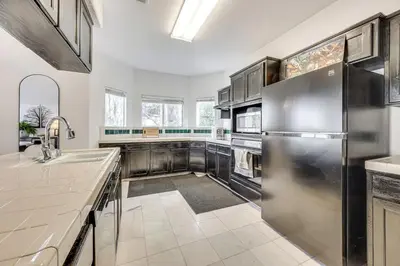 a kitchen with a stainless steel refrigerator and cabinets at Rudraksha-Luxurious 5 BR House, Prime Location, Shopping, Dining, Medical, Education, Tourist Attractions in Fresno