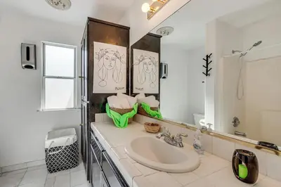 a bathroom with a sink and a mirror at Rudraksha-Luxurious 5 BR House, Prime Location, Shopping, Dining, Medical, Education, Tourist Attractions in Fresno
