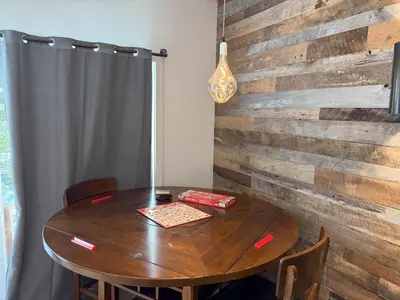 a dining room table with a wooden wall at Updated Cabin near Beach&Ski HotTub Sauna Pets EV in Tahoe City