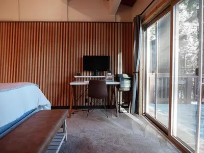 a bedroom with a bed and a desk with a computer at Updated Cabin near Beach&Ski HotTub Sauna Pets EV in Tahoe City