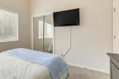 a bedroom with a bed and a tv on the wall at Family Home Near Folsom Lake in El Dorado Hills! in El Dorado Hills