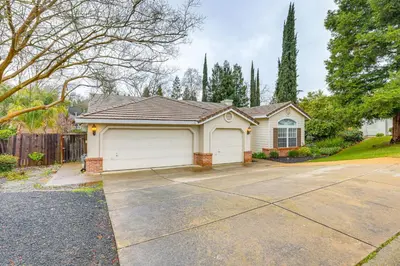 a house with a white garage in a driveway at Family Home Near Folsom Lake in El Dorado Hills! in El Dorado Hills