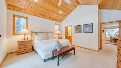 a bedroom with a bed and a wooden ceiling at Pinewood Lodge by AvantStay Cozy Cabin Near Ski Resorts Hiking in Truckee