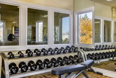 a gym with a row of mirrors and a bench at New Elegant 1BR Retreat Heated Pool Gym & Sauna in Reno