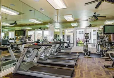 a gym with treadmills and elliptical machines at New Stylish 1BR Apt with Heated Pool Gym & Yoga Studio in Reno