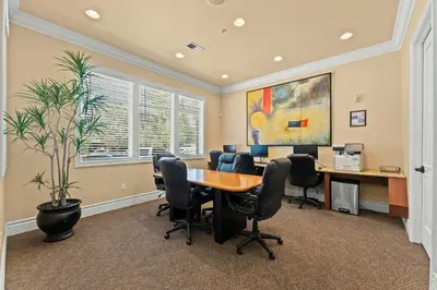 an office with a table and chairs and a plant at New Stylish 1BR Apt with Heated Pool Gym & Yoga Studio in Reno