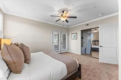 a bedroom with a bed and a ceiling fan at New Cozy & Stylish 1BR with Heated Pool Relaxing Spa & Sauna in Reno