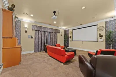 a living room with red chairs and a projection screen at New Cozy & Stylish 1BR with Heated Pool Relaxing Spa & Sauna in Reno