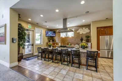 a kitchen with a large island with bar stools at New Cozy & Stylish 1BR with Heated Pool Relaxing Spa & Sauna in Reno