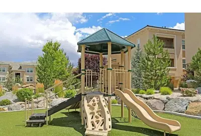 a playground with a slide in a park at New Cozy & Stylish 1BR with Heated Pool Relaxing Spa & Sauna in Reno