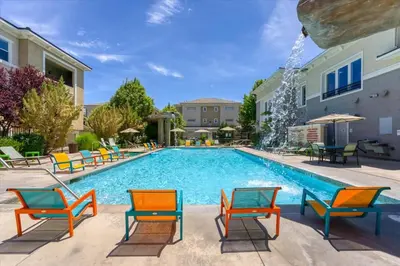 a swimming pool with colorful chairs and tables at New Upscale 1BR Stay with Mini Golf Sauna & Heated Pool in Reno
