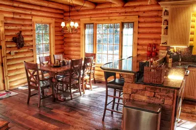 a dining room with a table and chairs in a cabin at Family-Friendly Log Cabin Rental in California's Gold Country near Sacramento in Volcano