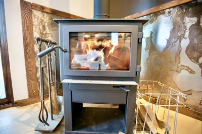 a fireplace with a television on top of it at Luxury Design Rental with Breathtaking Mountain Views in Lone Pine, California in Lone Pine