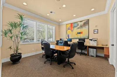 an office with a table and chairs and a plant at New Cozy 1BR Apt with Gym Sauna & Heated Pool Access in Reno