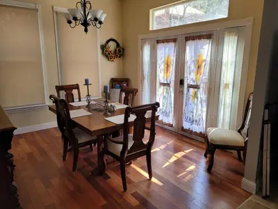 a dining room with a wooden table and chairs at Newly remodeled mountain home! in Floriston