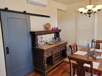 a dining room with a table and a wooden door at Newly remodeled mountain home! in Floriston