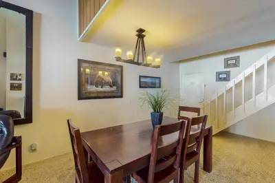 a dining room with a wooden table and chairs at Summit 295 in Mammoth Lakes