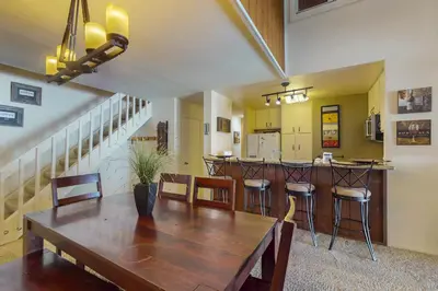 a dining room and kitchen with a table and chairs at Summit 295 in Mammoth Lakes