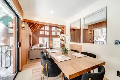 a dining room with a wooden table and chairs at Ski, Hike and Fish Cabin with Deck in Soda Springs! in Soda Springs