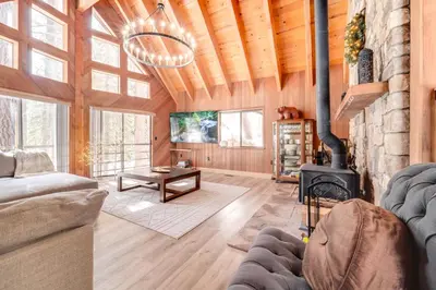 a living room with a couch and a fireplace at Ski, Hike and Fish Cabin with Deck in Soda Springs! in Soda Springs